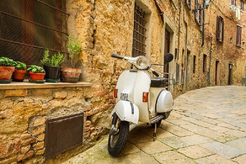 Scooter in alley in summertime.